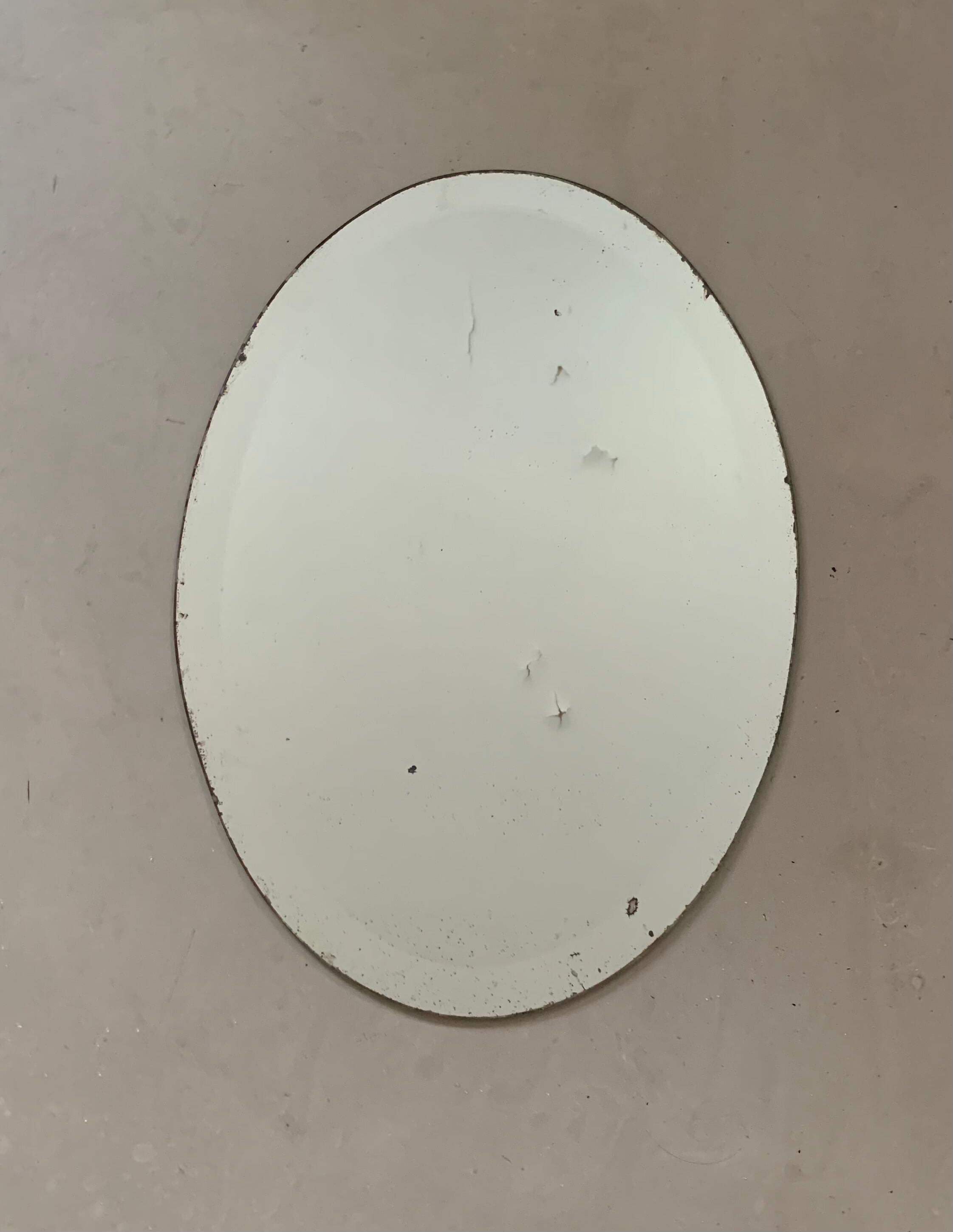 Old bevelled stitched oval mirror