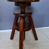Old wooden stool has adjustable screw