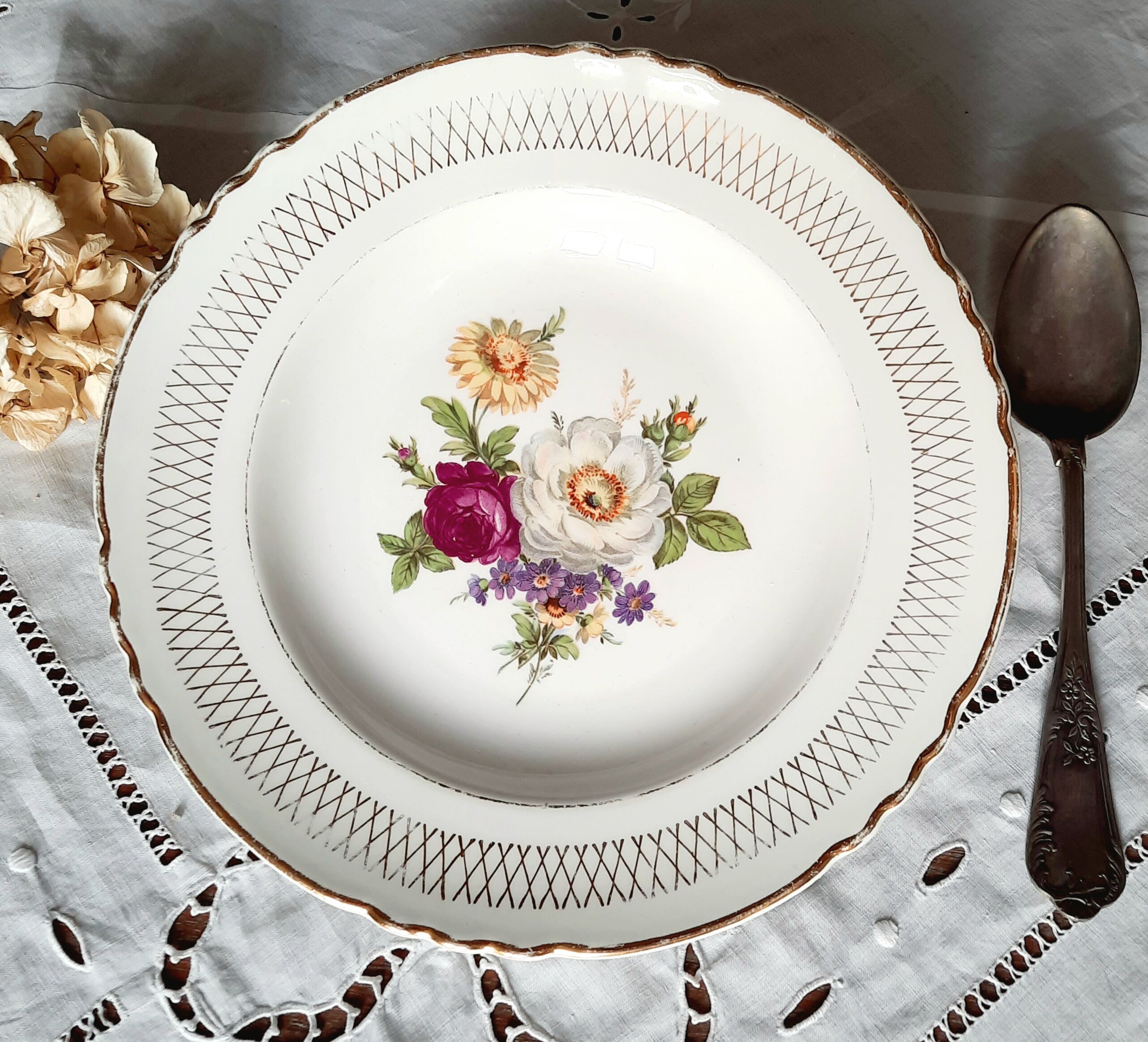 Old hollow plates mismatched in earthenware with gilded edges