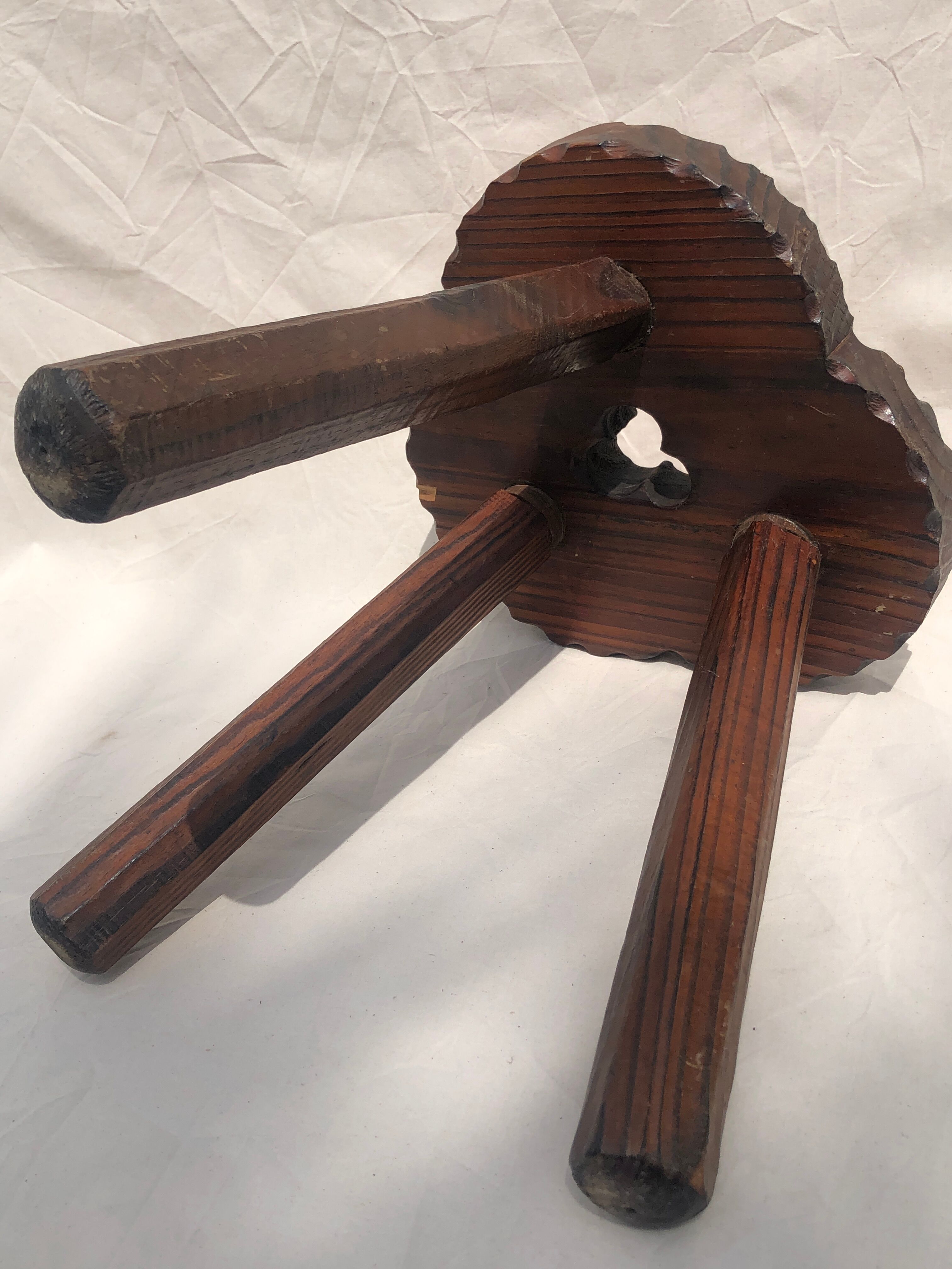 Chiseled wooden tripod stool