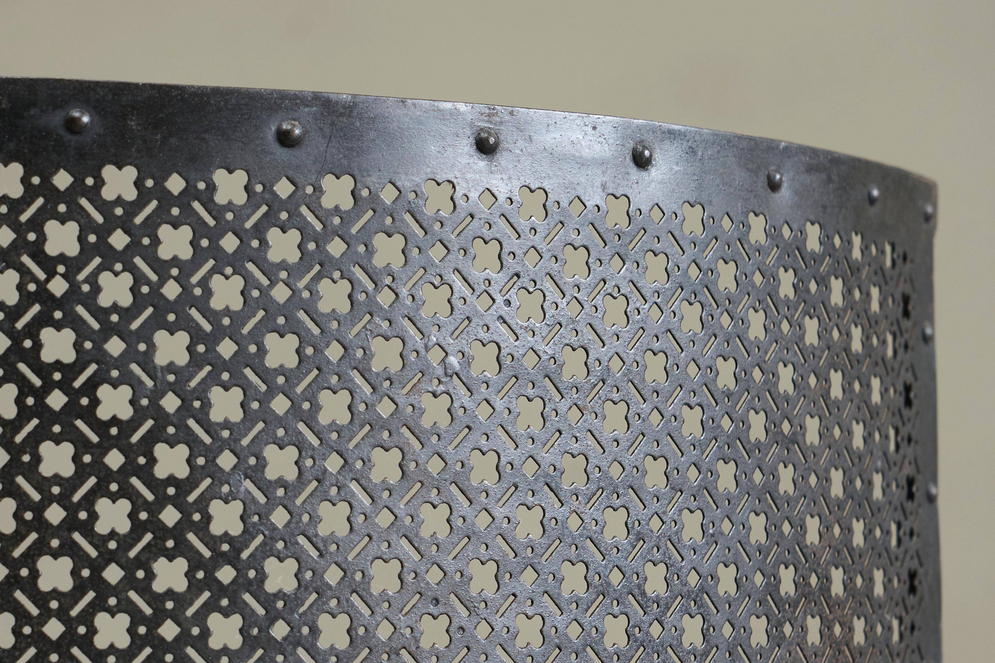 Half-moon antique wrought iron fire screen from the 19th century.
