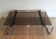 Coffee table in chrome, leather, and smoked glass.