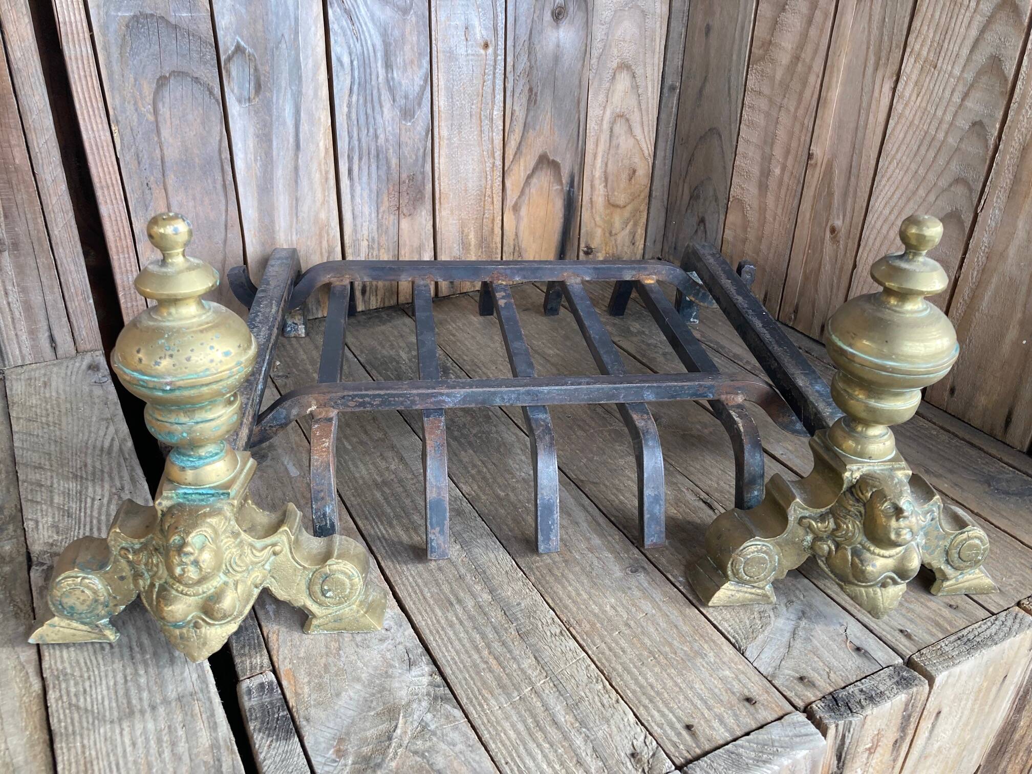Pair of andirons and grates in cast iron and bronze with gilded grotesques, 17th century