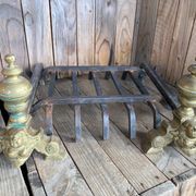 Pair of andirons and grates in cast iron and bronze with gilded grotesques, 17th century