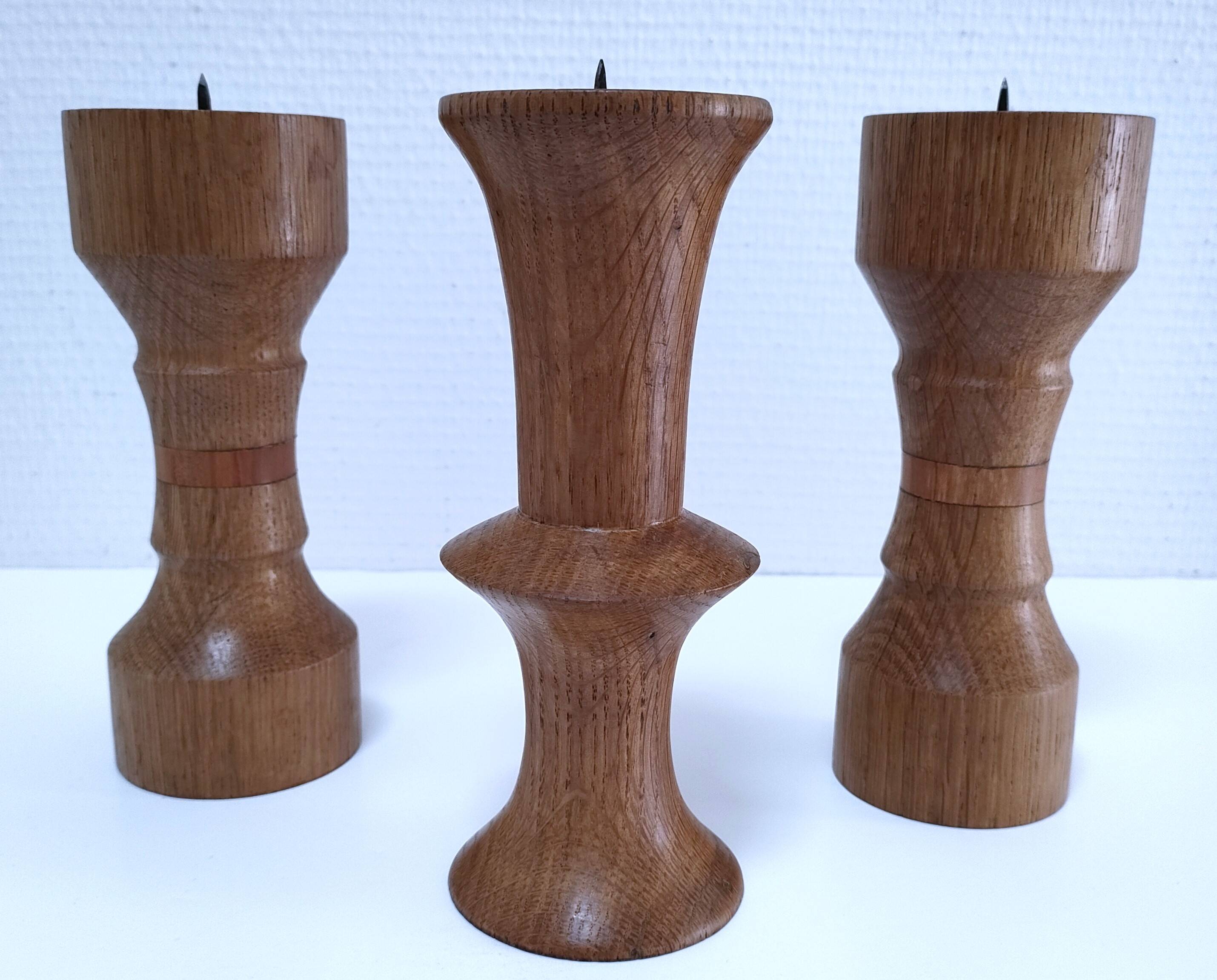 Three vintage patinated solid wood candlesticks