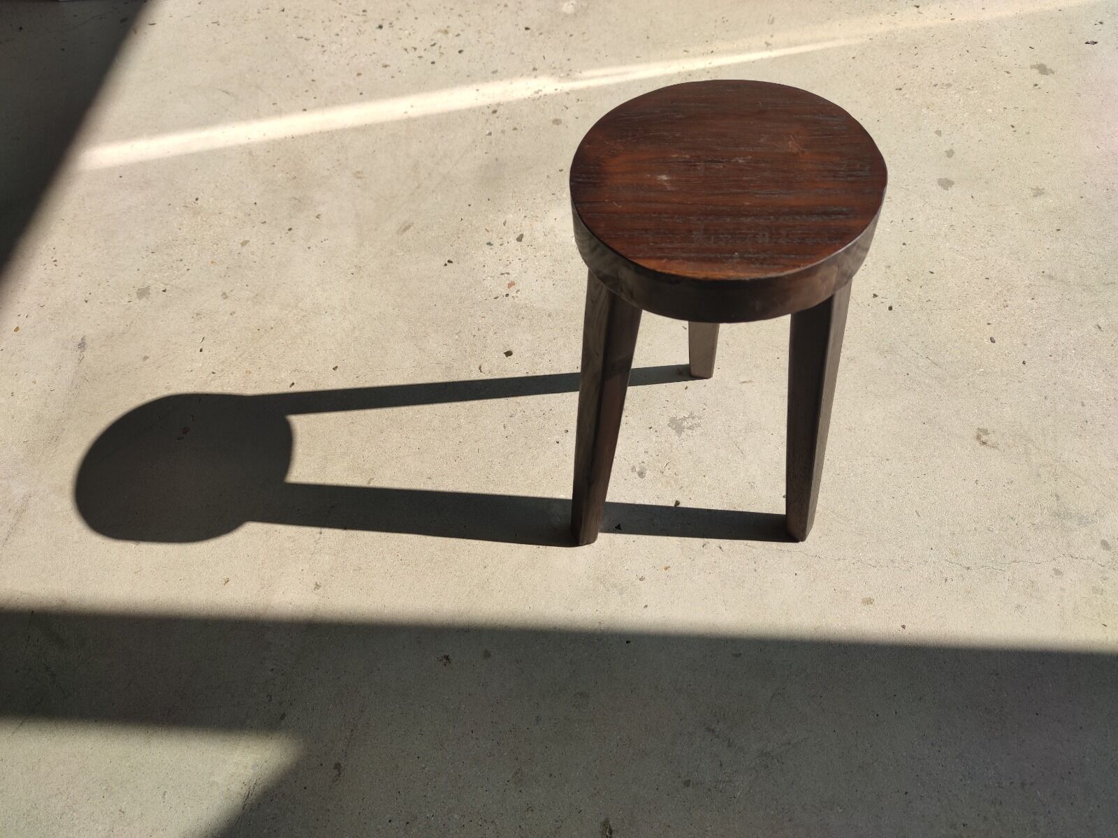 Small high tripod stool in brown solid wood