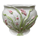 White ceramic pot cache of flower slip and old green foliage