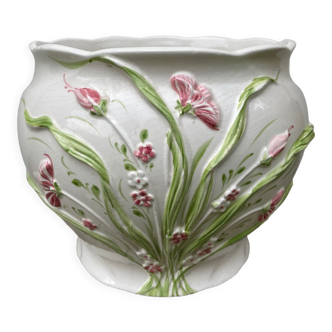 White ceramic pot cache of flower slip and old green foliage
