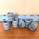 6 vintage egg cups on a wall shelf