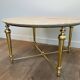 Brass coffee table with a white marble top.