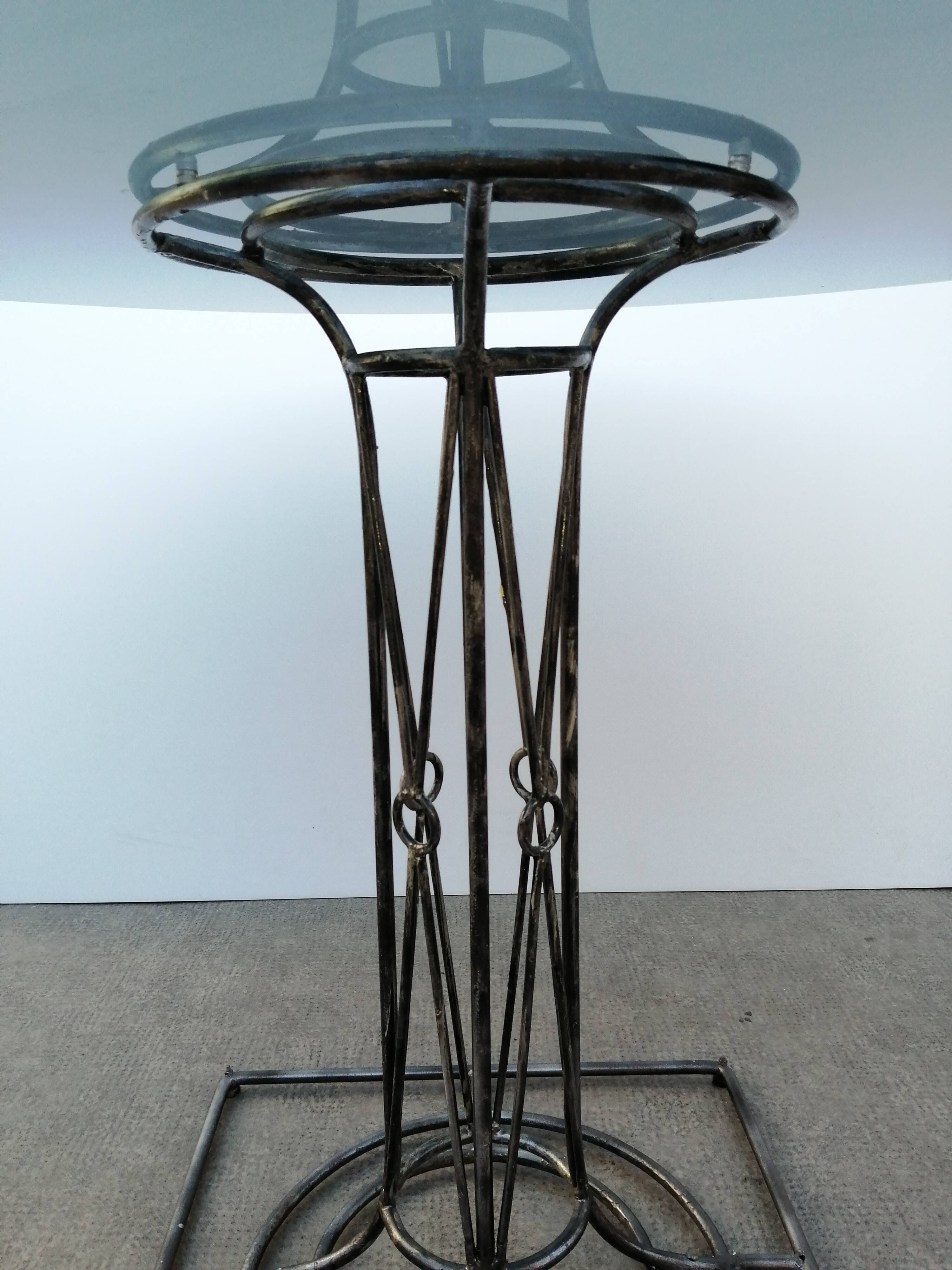 Wrought iron dining table with its round smoked glass top, vintage 1980