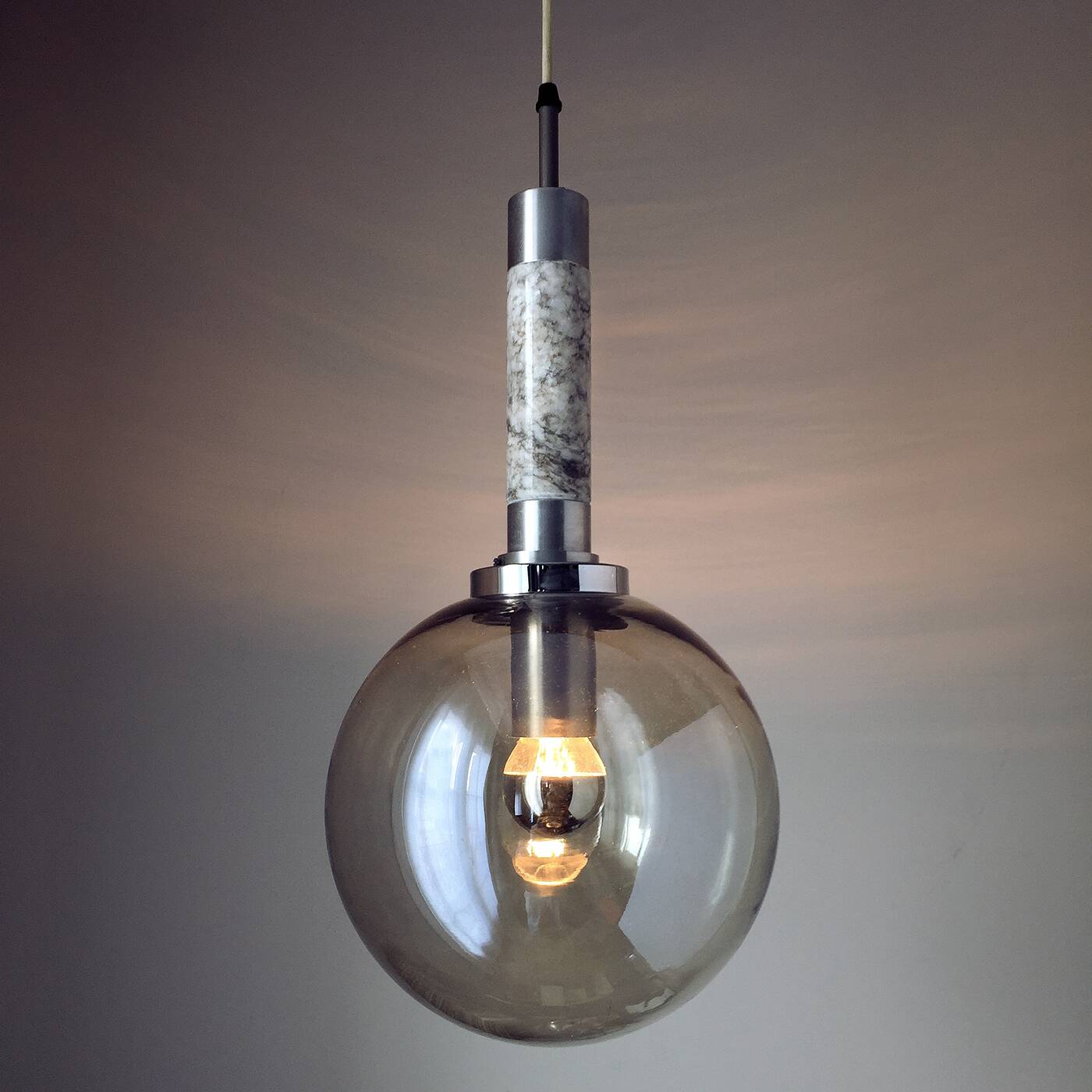 Scandinavian pendant light in brushed stainless steel marble and smoked glass globe. 1970