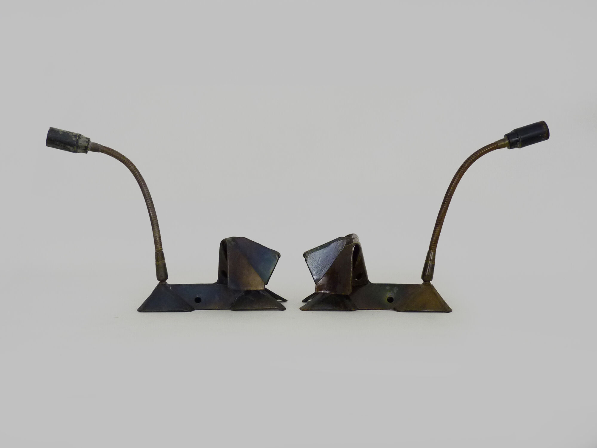 Pair of cast iron wall sconces with articulated arm, dog shape. Vintage