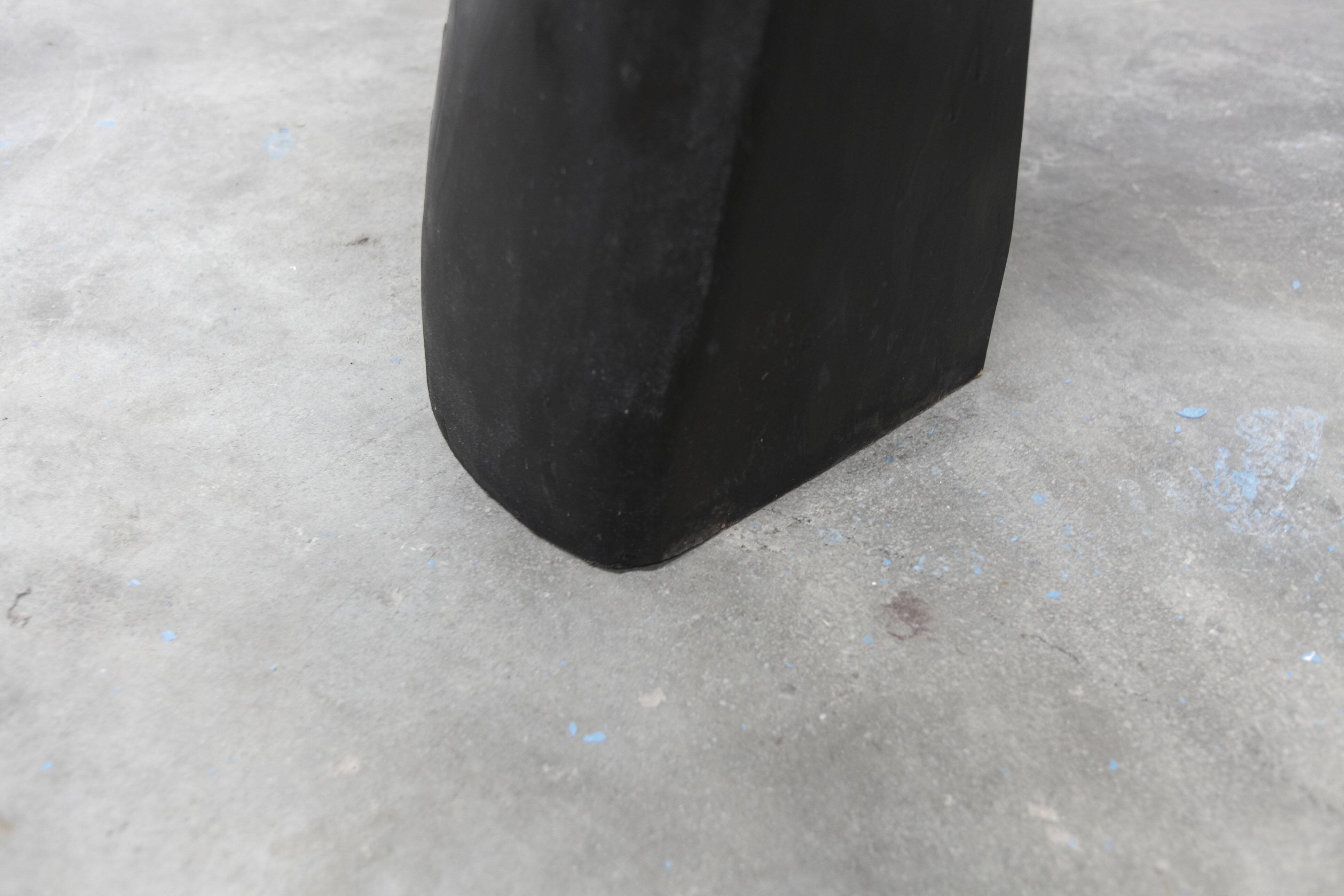 Black armchair chair in carved wood in the shape of a hand