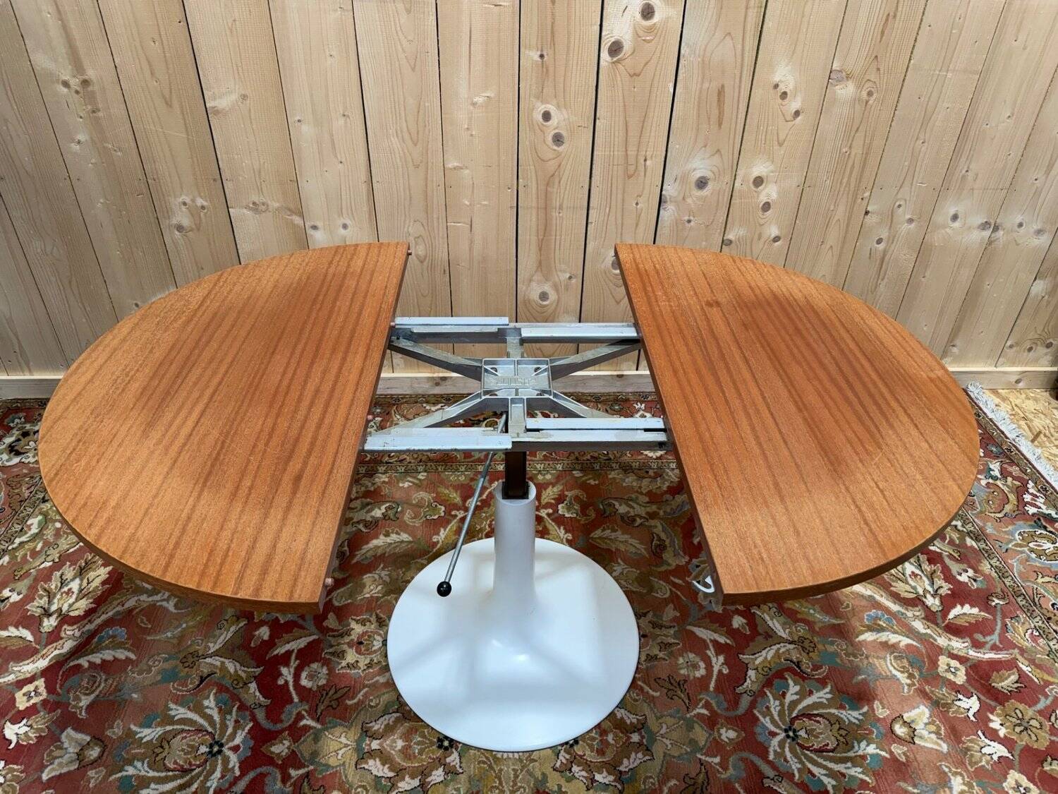 Round dining table with tulip base, 1960s design.