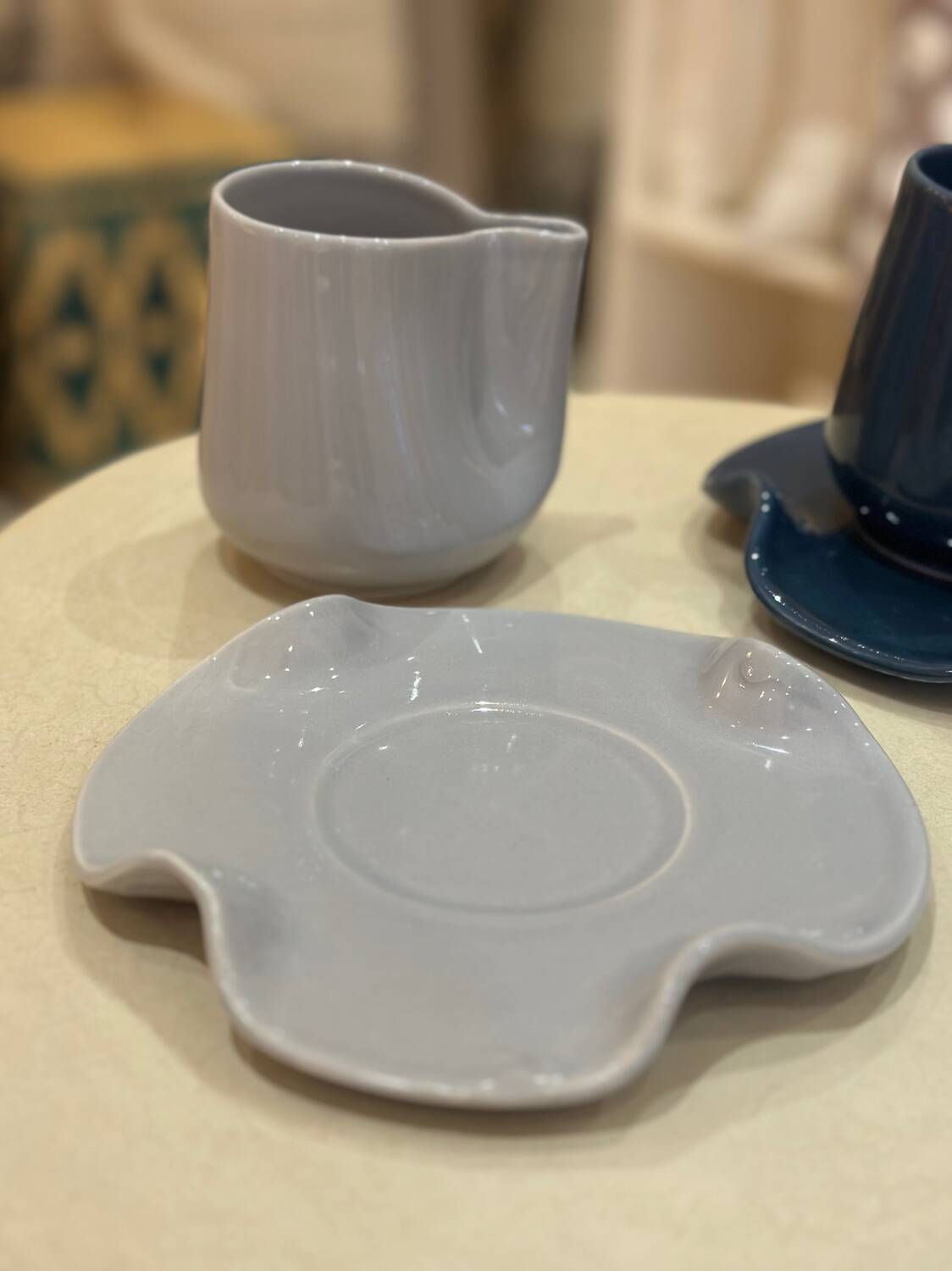 Set of ceramic artisan mugs with blue-grey pop water lily design.