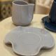 Set of ceramic artisan mugs with blue-grey pop water lily design.
