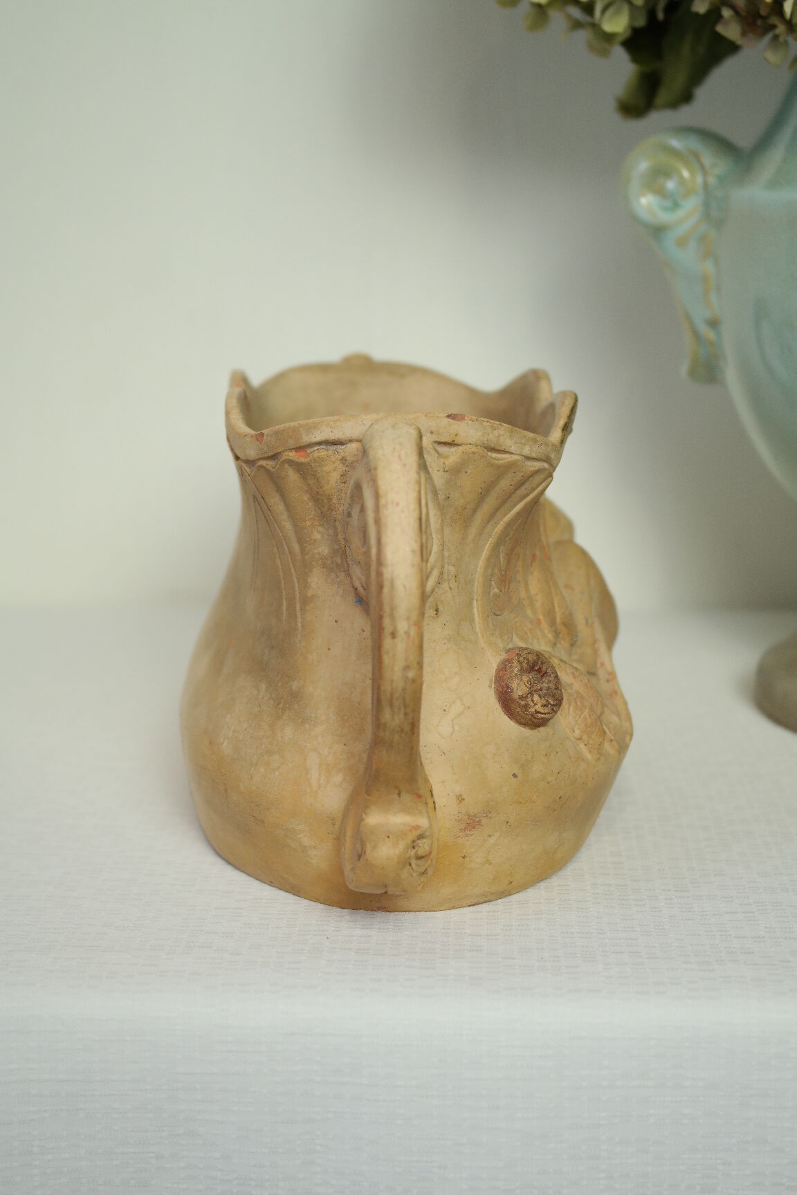 Art Nouveau jardinière with bas-reliefs in terracotta.