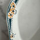 Longwy ramekin with blue and orange floral decoration.