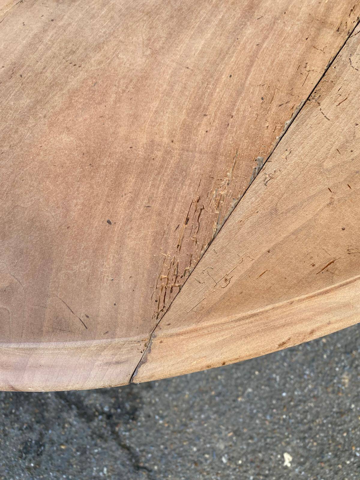 Renovated round extendable dining table with leaves made of solid wood.