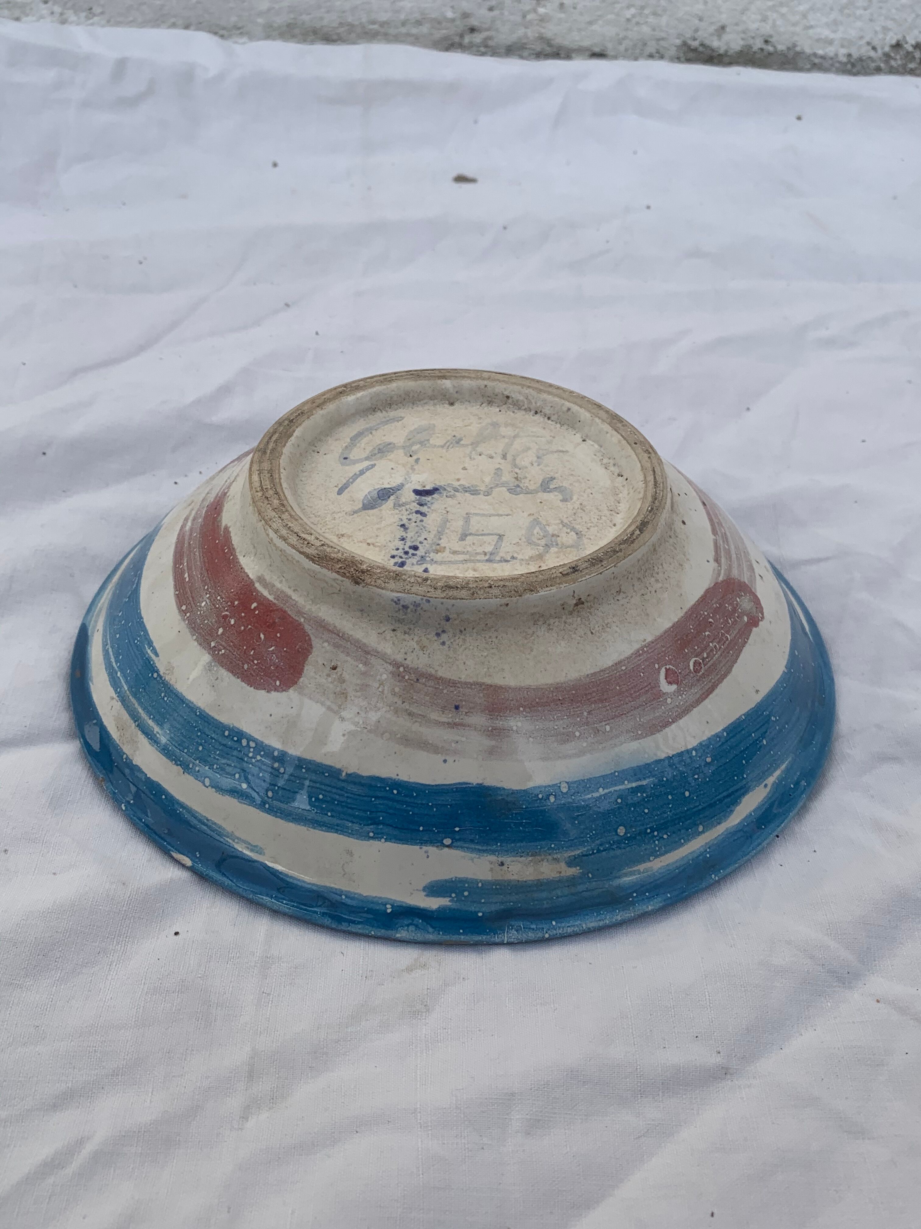 Hand-painted plate decorated with a colorful face 60s