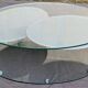 Coffee table with rotating glass tops by Antoine Motard.