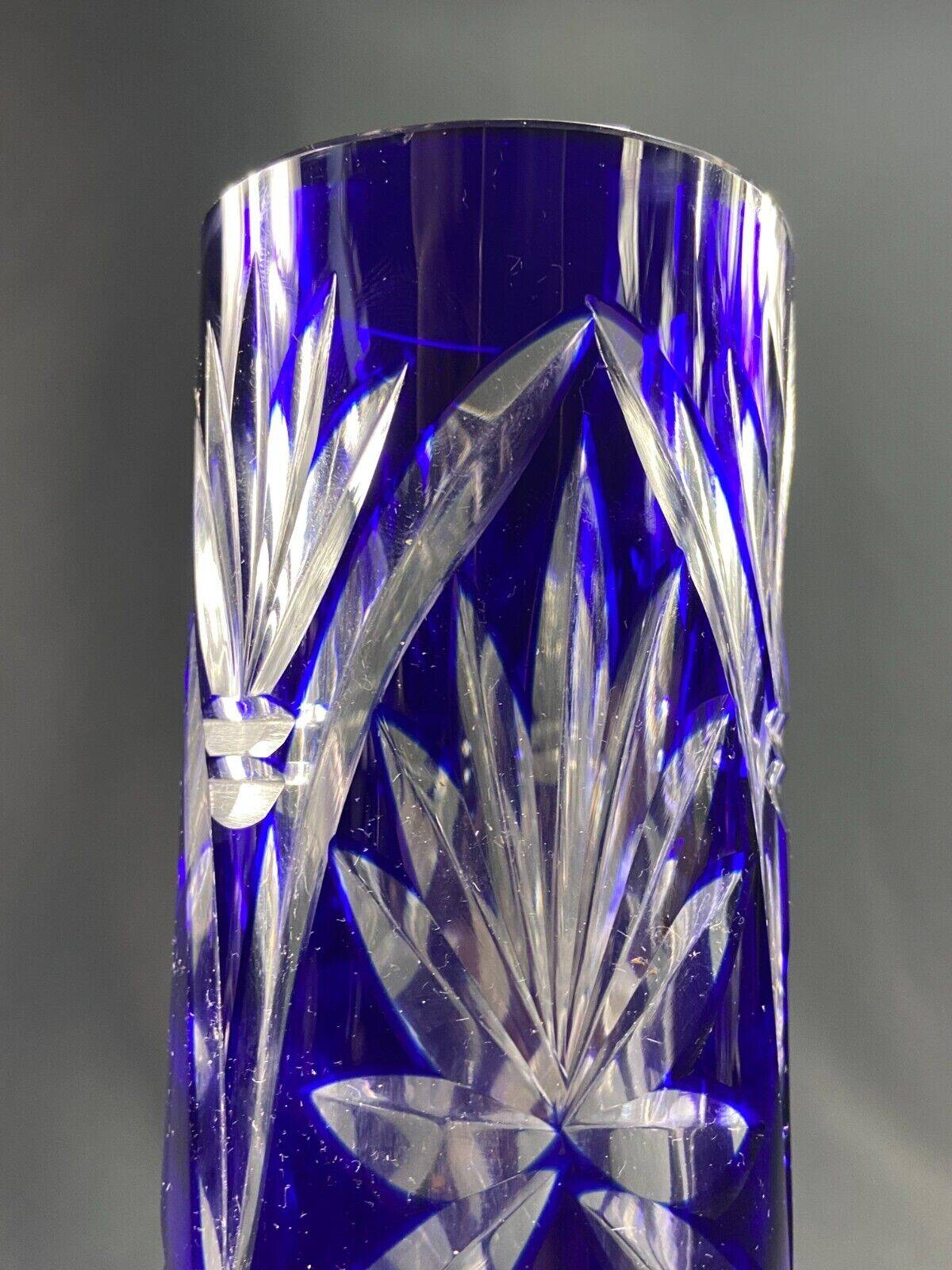 Tubular vase on a pedestal in cut blue Bohemian crystal.