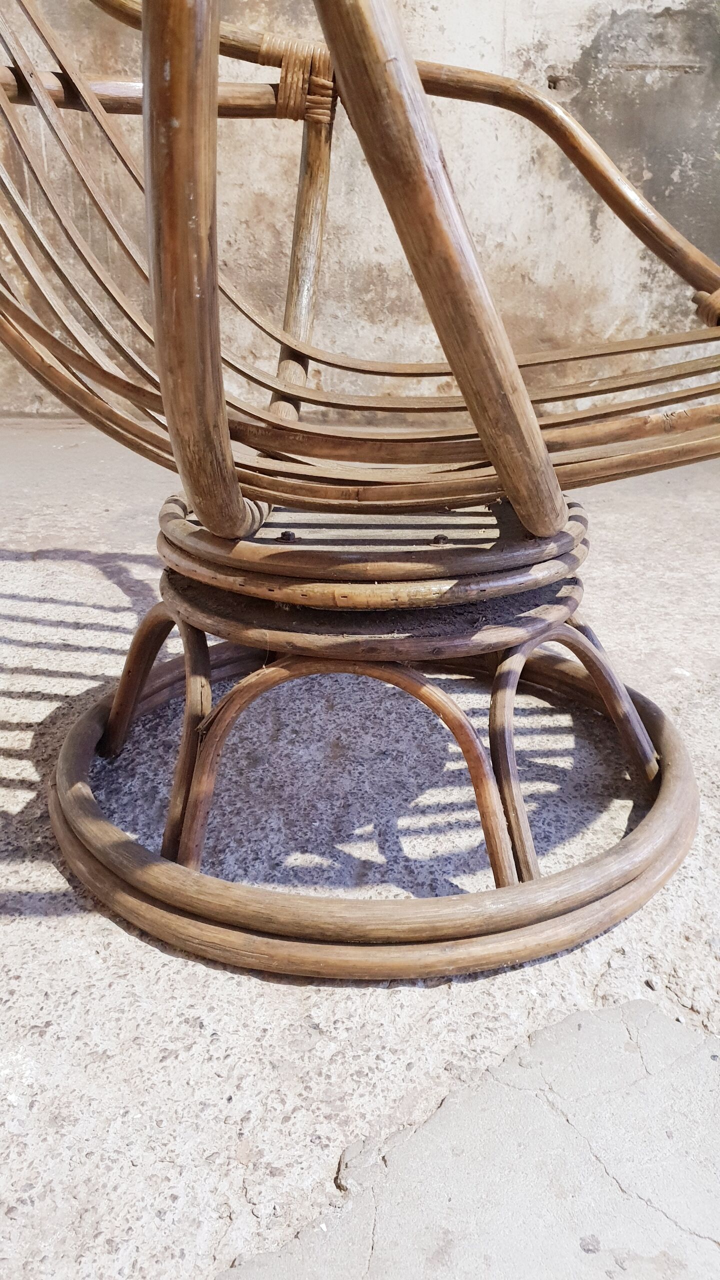 Antique swivel rattan armchair
