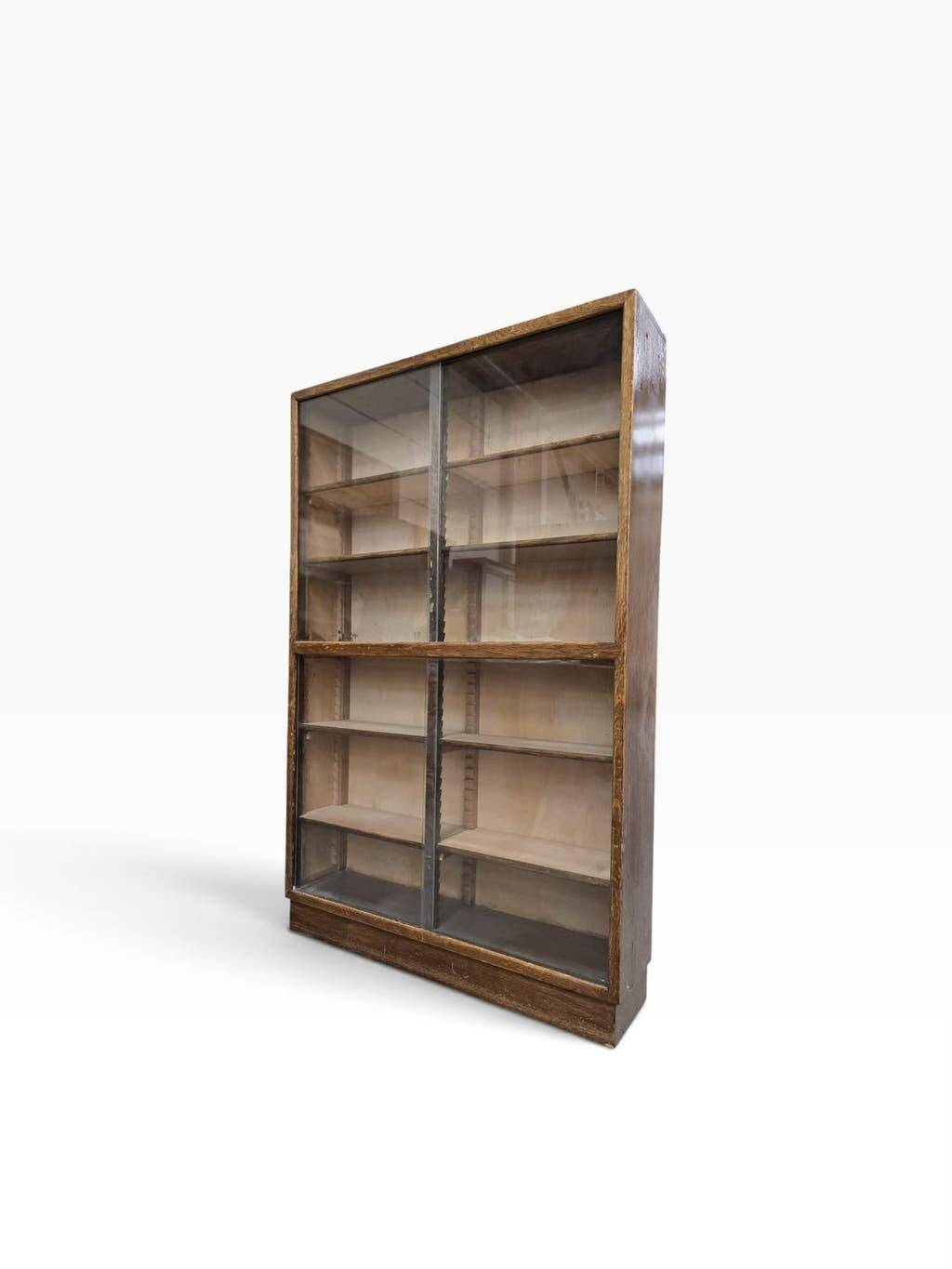 Vintage shallow wooden display shelf with sliding glass doors.