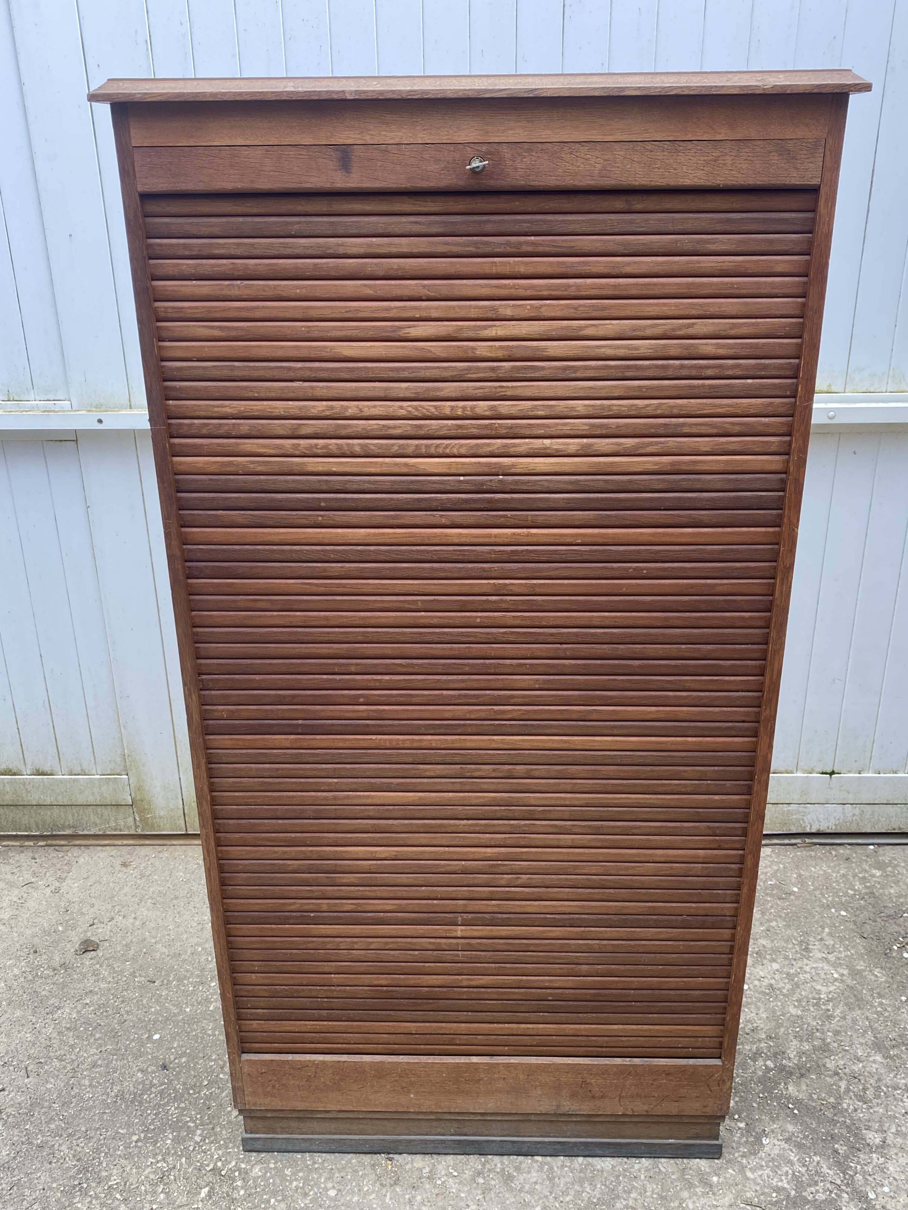 Oak two-column filing cabinet with curtains.