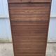 Oak two-column filing cabinet with curtains.