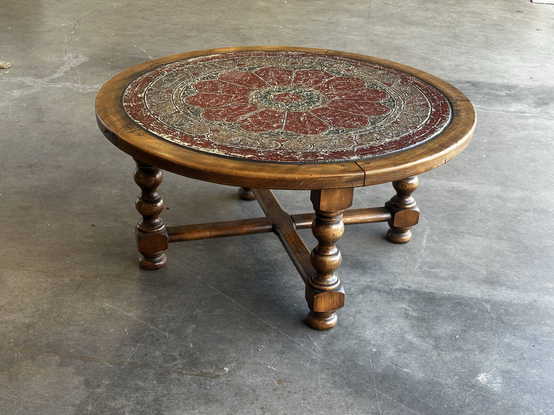 Vintage coffee table in turned wood and leather with astrological decoration.