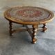 Vintage coffee table in turned wood and leather with astrological decoration.