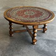 Vintage wooden turned coffee table with leather and astrological decoration.