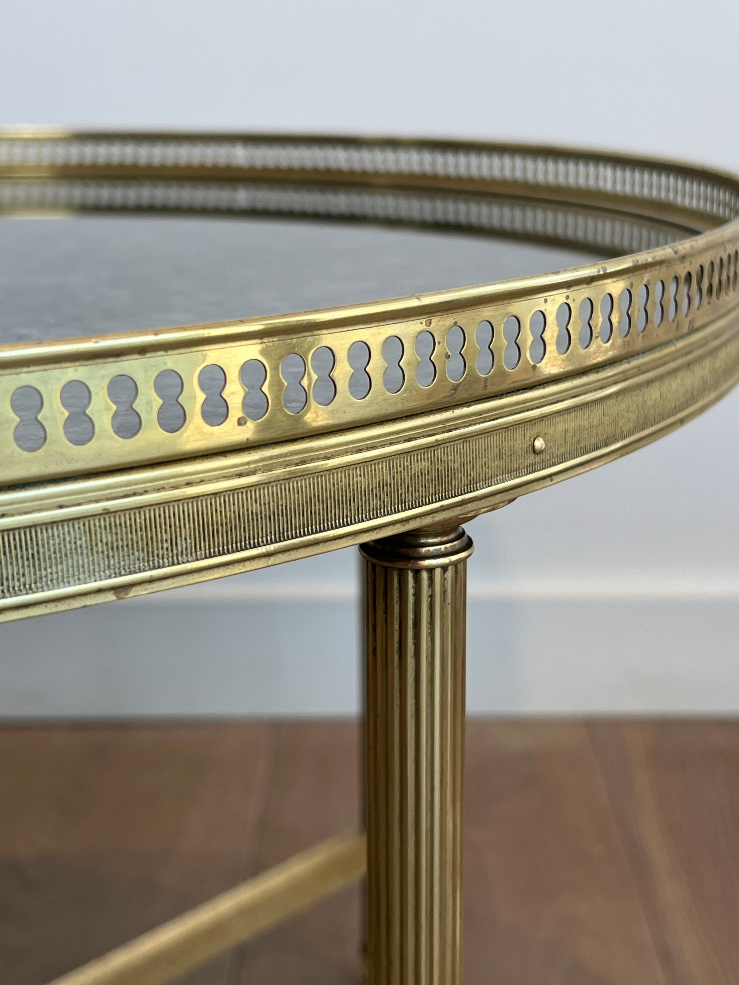 Brass coffee table with a vintage mirror top from the Baguès house.