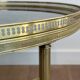 Brass coffee table with a vintage mirror top from the Baguès house.