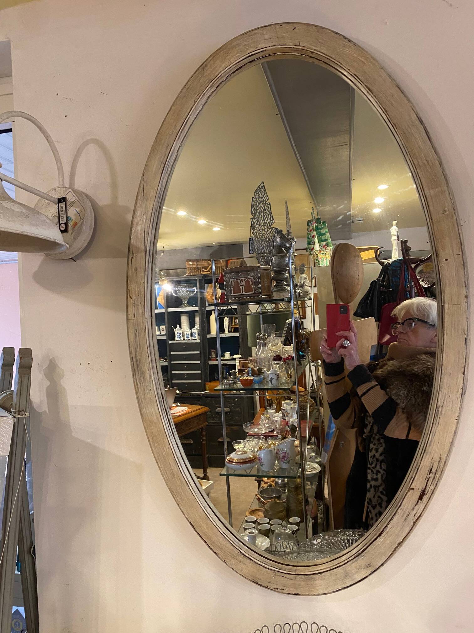 Large old oval mirror with beige patina wooden frame early 20th century