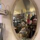 Large old oval mirror with beige patina wooden frame early 20th century