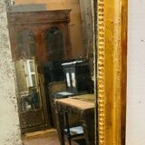Louis XVI mirror in carved and gilded wood with leaf 18th century