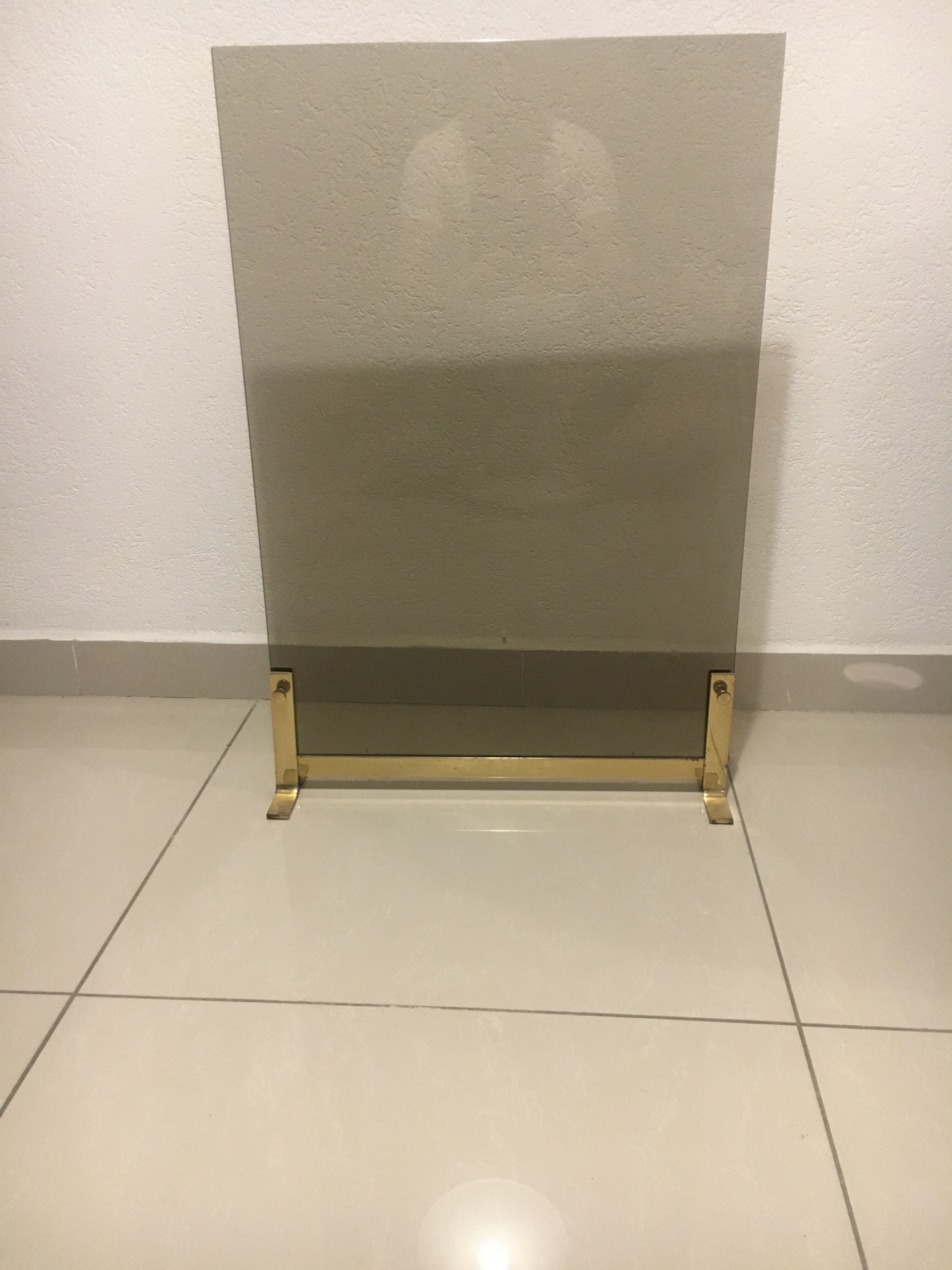 Fireplace screen in smoked glass and brass