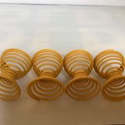 Four yellow spiral spring egg cups