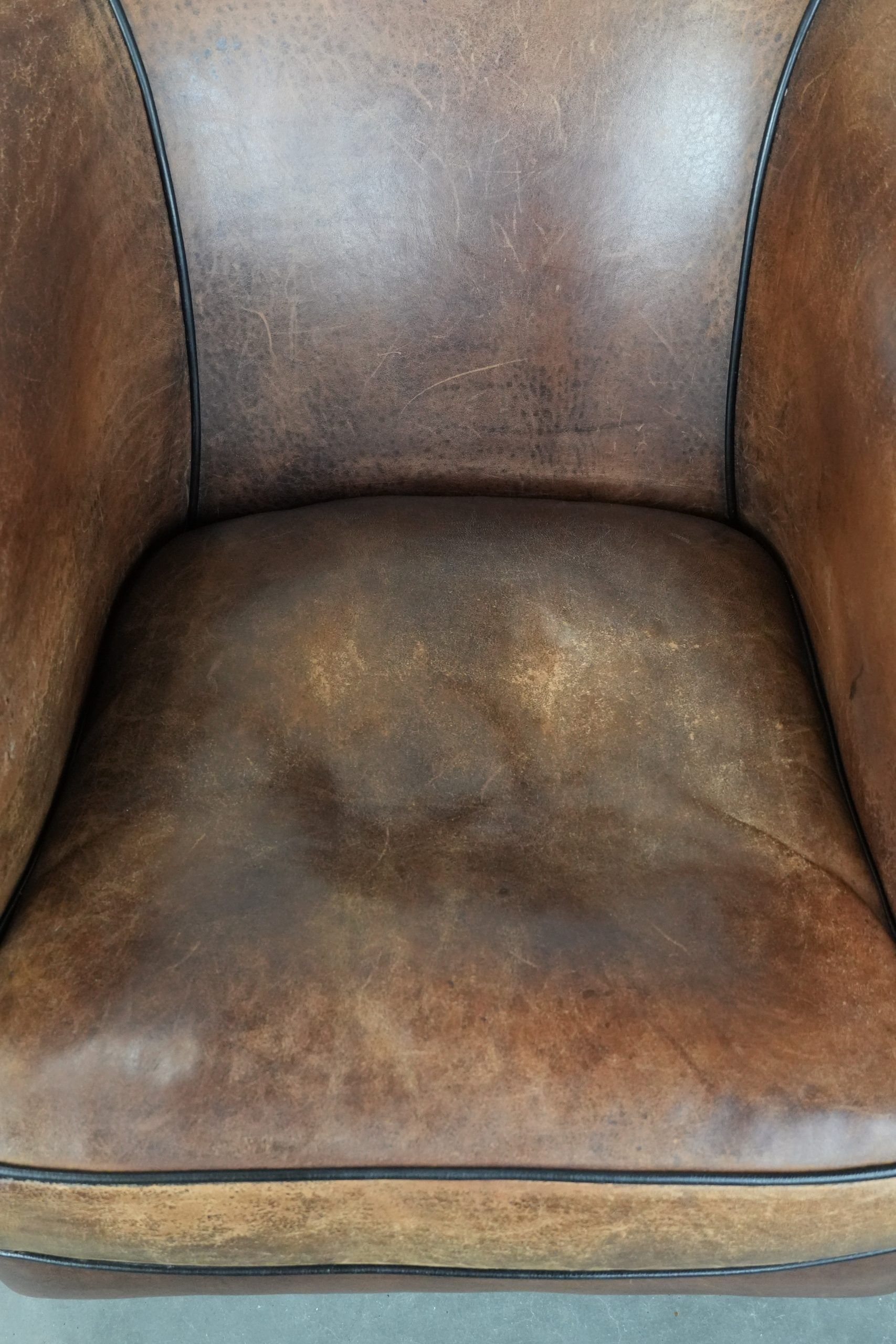 Sturdy vintage sheepskin club armchair with a beautiful patina