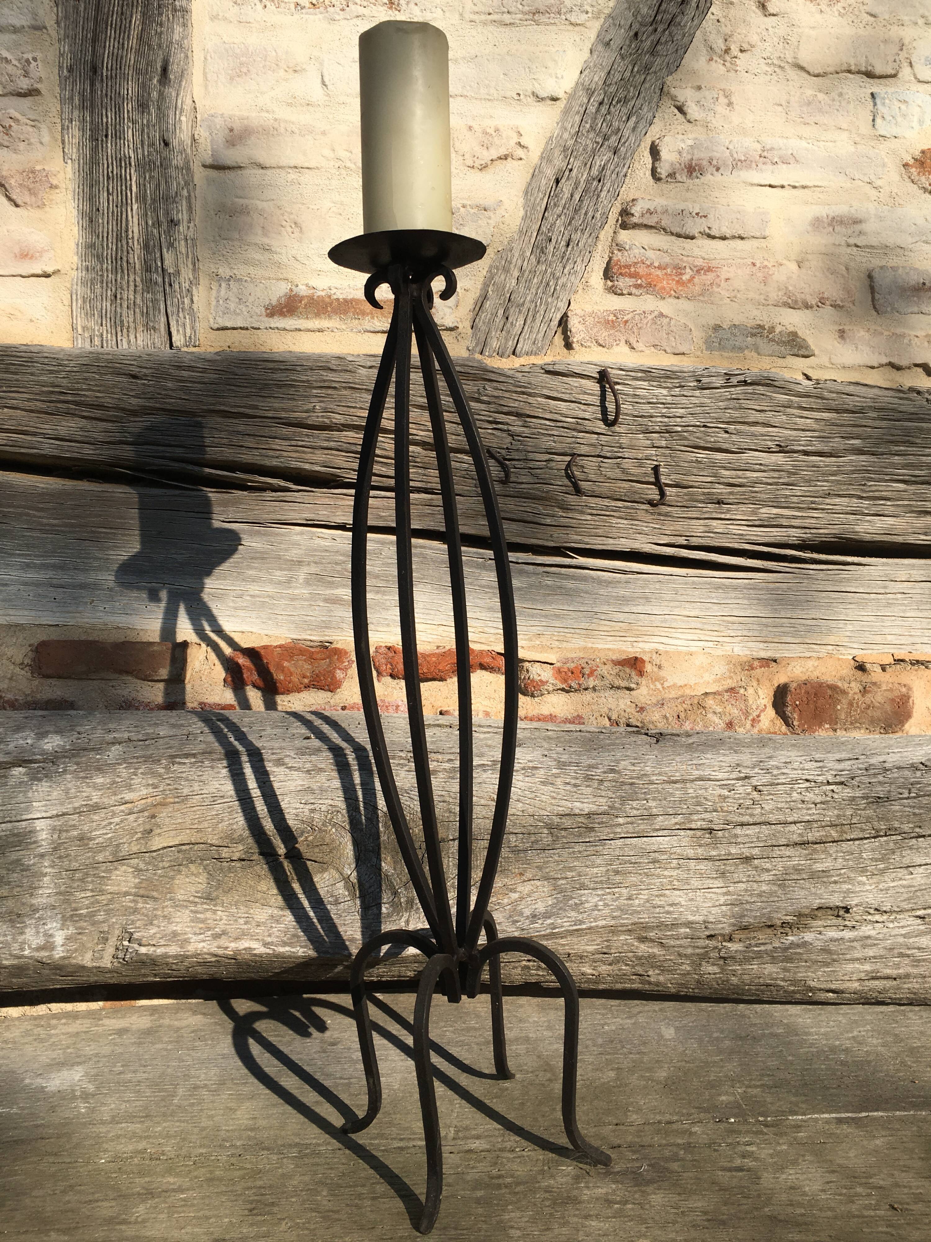 Wrought iron candlestick on feet
