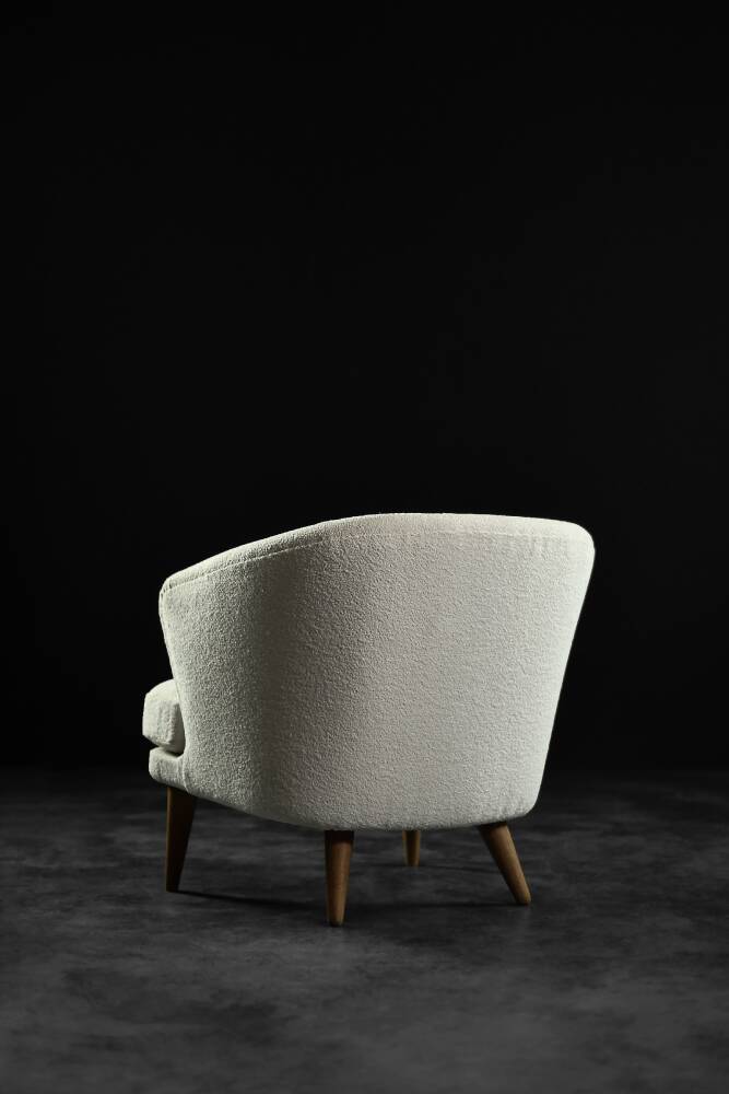 Low oak armchair with modern mid-century Scandinavian fabric and rounded backrest, 1960s.