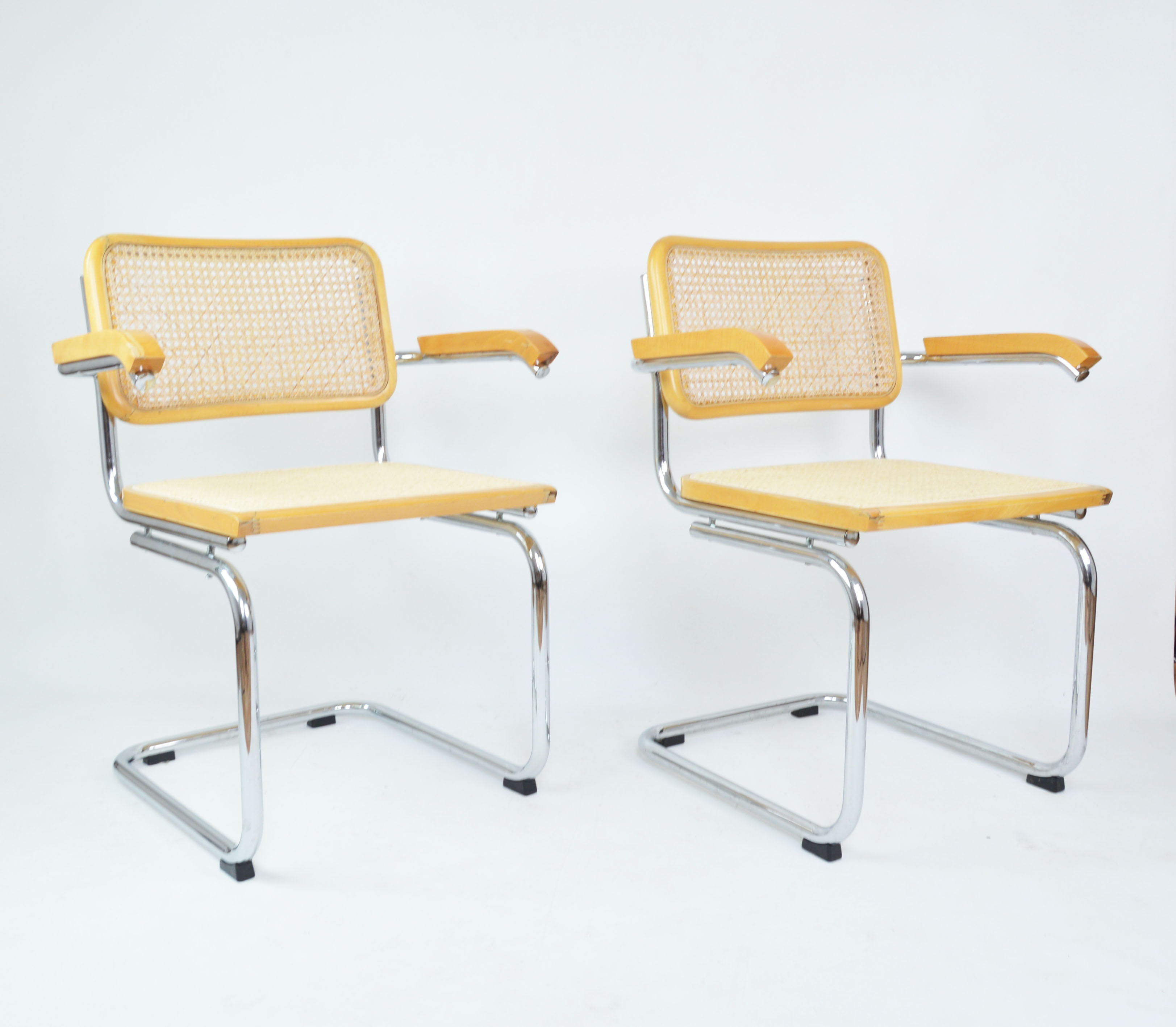 A pair of chairs with armrests, 1970s