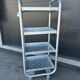 Four-wheeled dessert trolley with 4 perforated metal shelves.