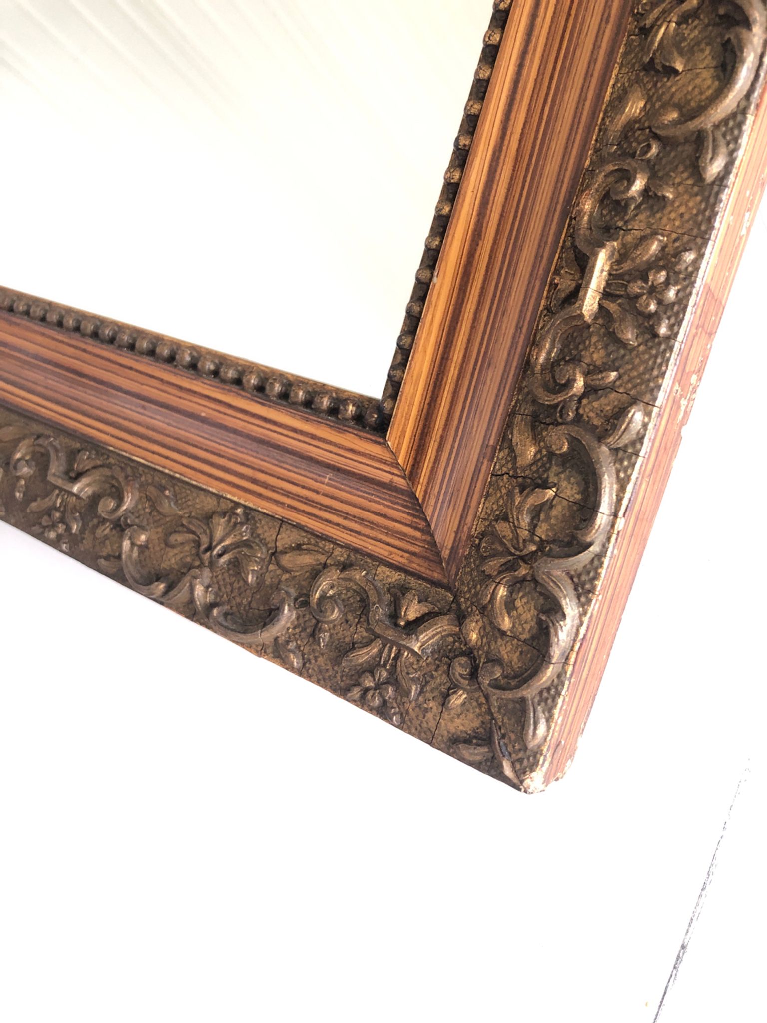 Old mirror with wooden frame and plaster moldings