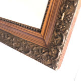 Old mirror with wooden frame and plaster moldings