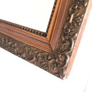 Old mirror with wooden frame and plaster moldings