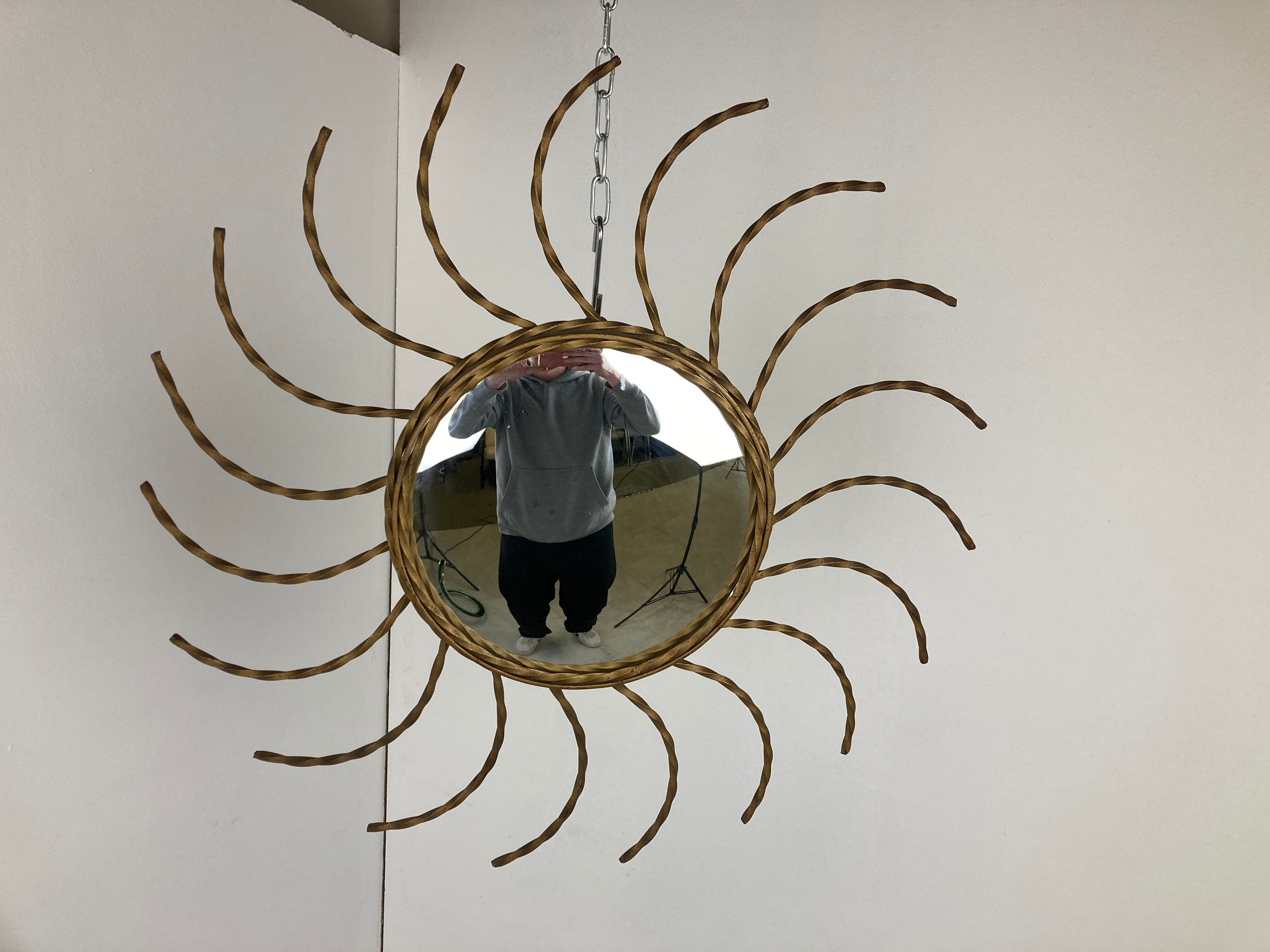 Mid century gold sunburst mirror with convex glass.